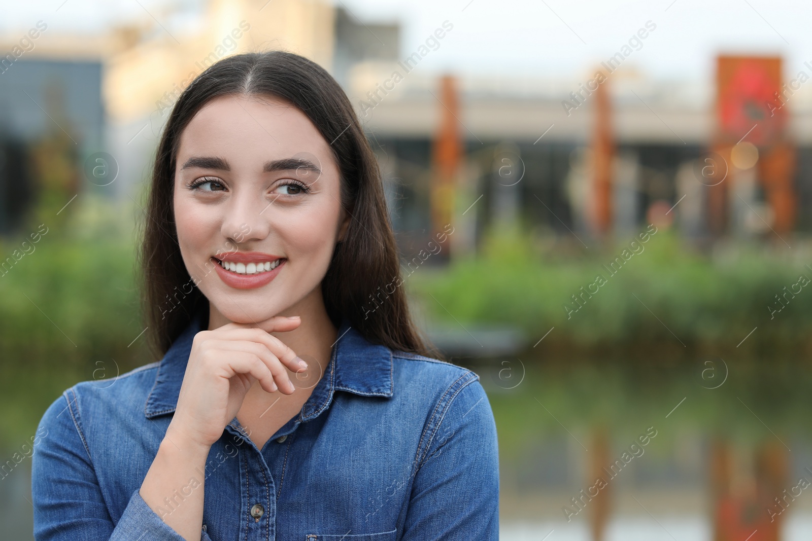 Photo of Portrait of beautiful woman outdoors. Attractive lady smiling and posing for camera. Space for text