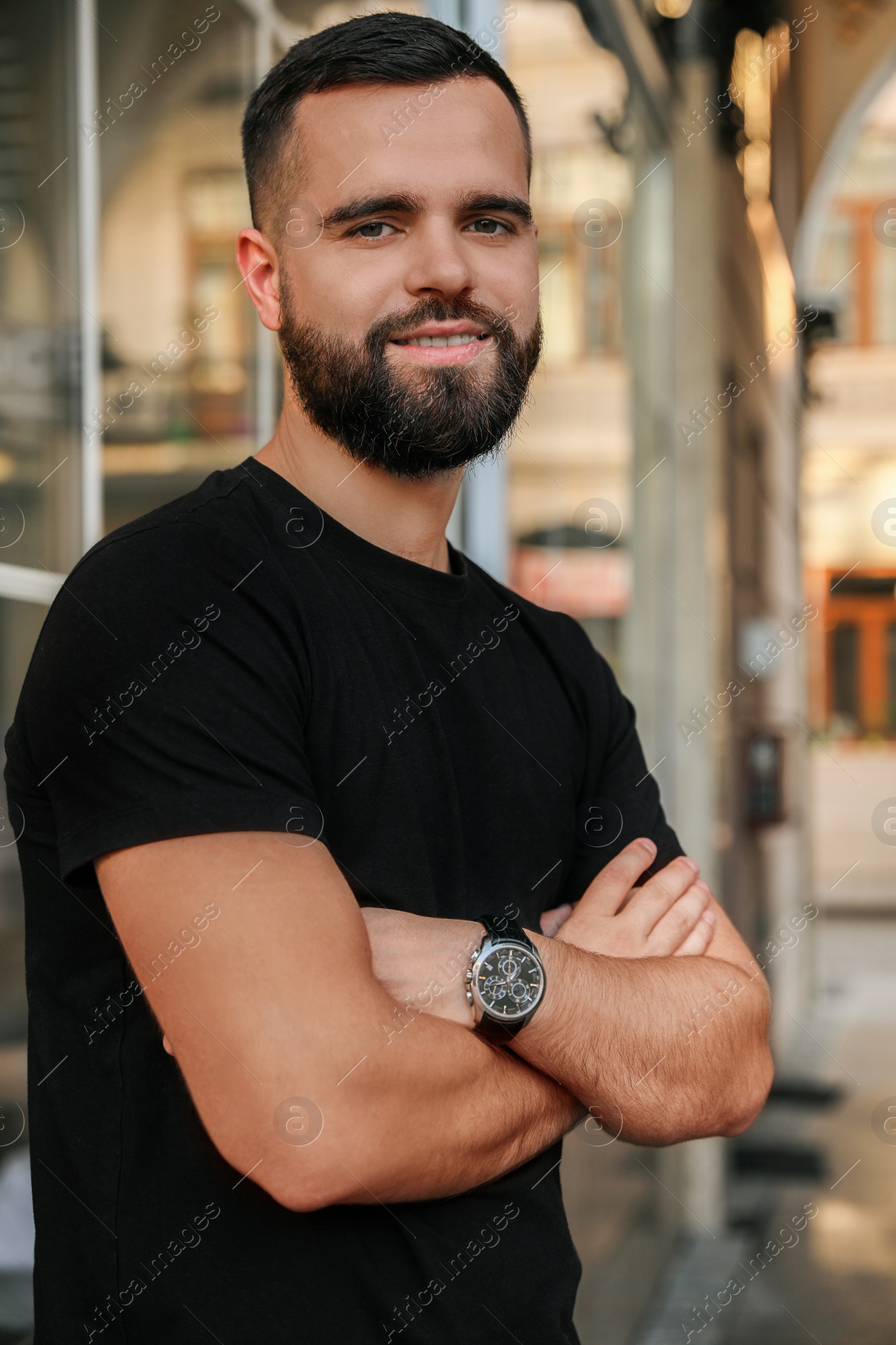 Photo of Portrait of happy handsome man near building outdoors