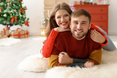 Happy young couple celebrating Christmas at home