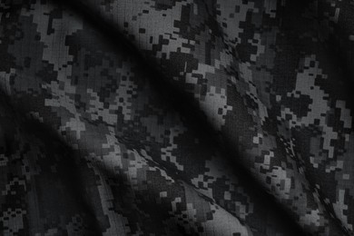 Image of Texture of crumpled camouflage fabric as background, top view. Black and white effect