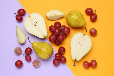 Photo of Fresh ripe pears and grapes on color background, flat lay