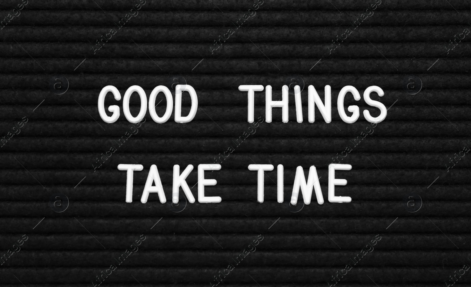 Photo of Black letter board with motivational quote Good Things Take Time, closeup view