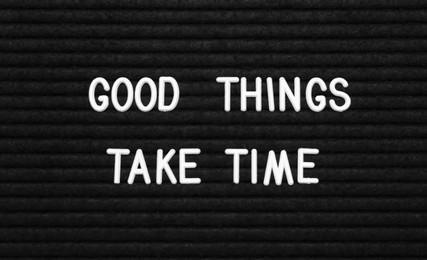 Photo of Black letter board with motivational quote Good Things Take Time, closeup view