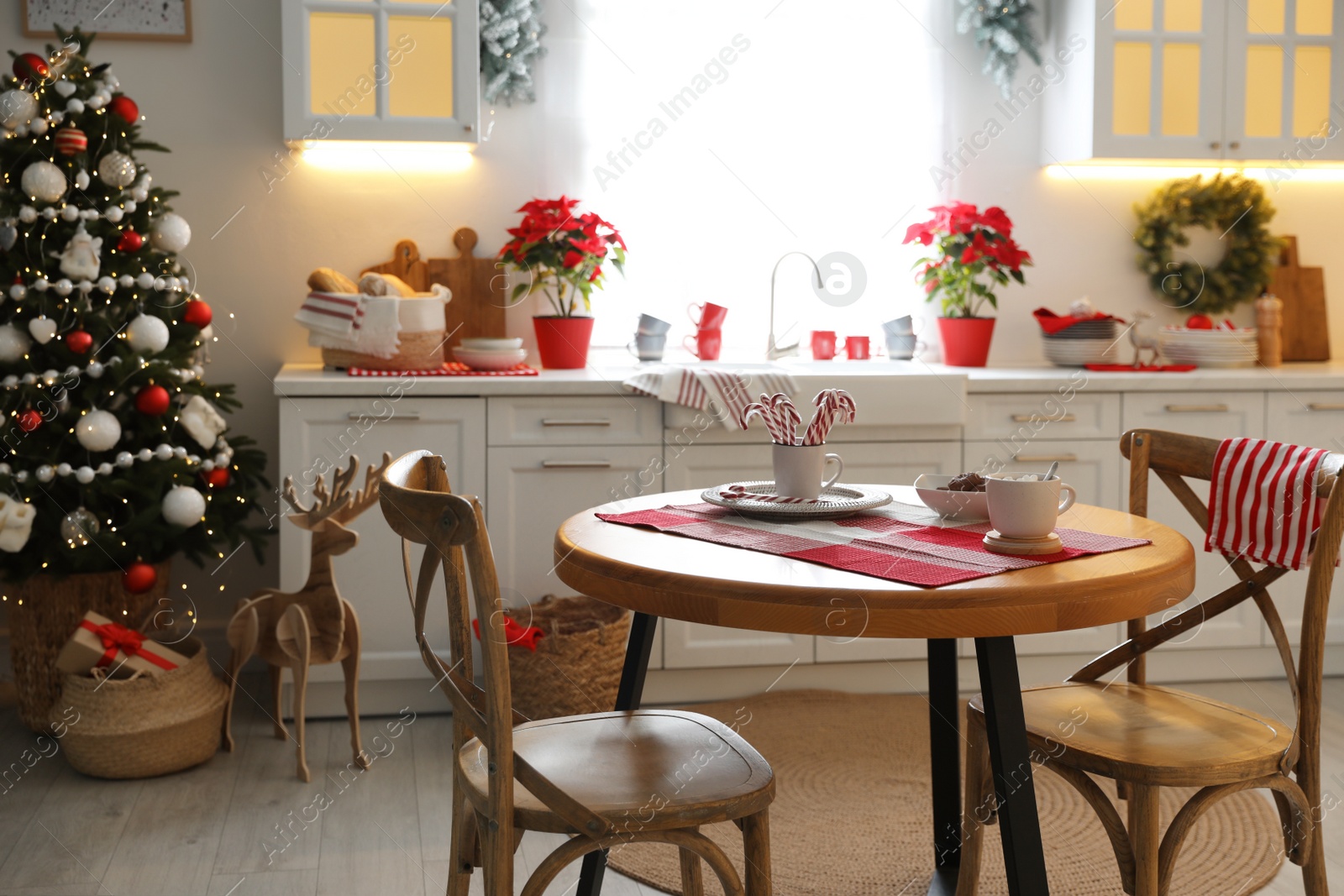 Photo of Beautiful kitchen interior with Christmas tree and festive decor