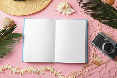 Photo of Flat lay composition with open book on pink background