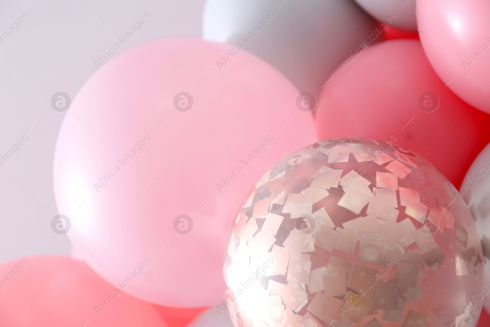 Photo of Beautiful colorful balloons on light background, closeup