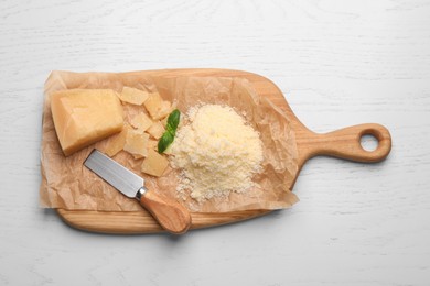 Photo of Delicious parmesan cheese on white wooden table, flat lay