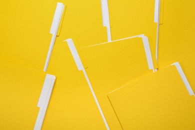 Photo of Many yellow files with documents as background, top view