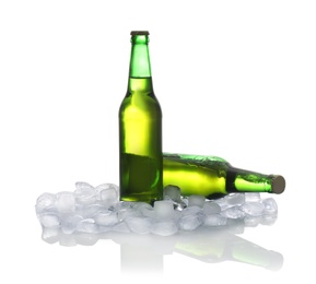 Photo of Bottles of beer and ice cubes on white background
