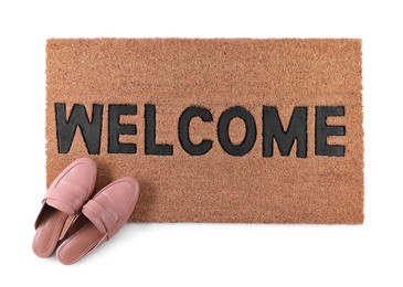 Stylish door mat with word Welcome and female shoes on white background, top view