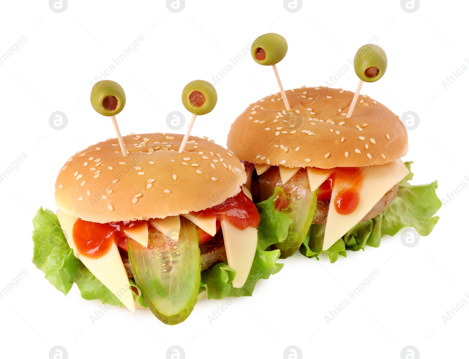 Photo of Cute monster burgers isolated on white. Halloween party food