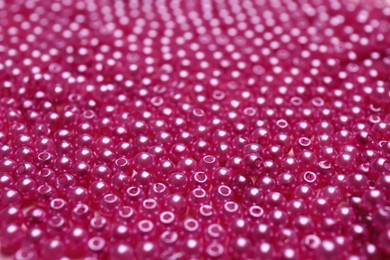 Photo of Many bright pink beads as background, closeup