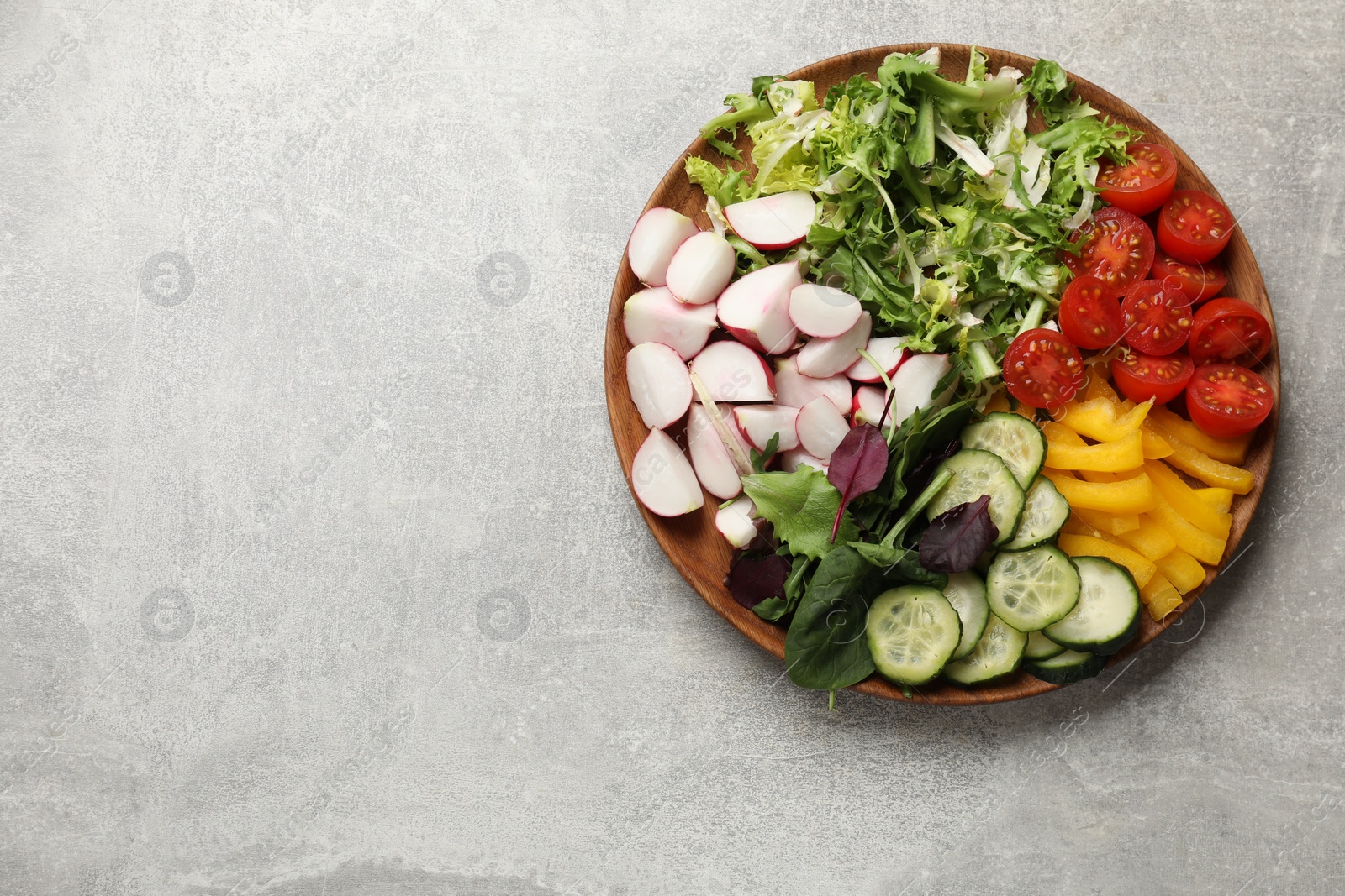 Photo of Vegetarian diet. Plate with tasty vegetables on light grey table, top view. Space for text