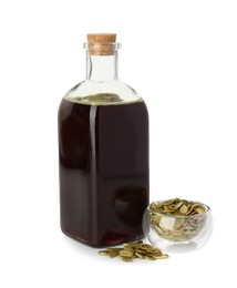 Photo of Vegetable fats. Pumpkin seed oil in glass bottle and seeds isolated on white