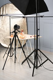 Photo of Professional equipment and composition with delicious desserts on table in studio. Food photography