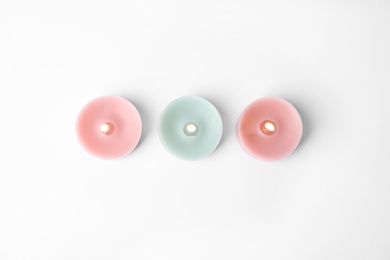 Photo of Color wax decorative candles isolated on white, top view