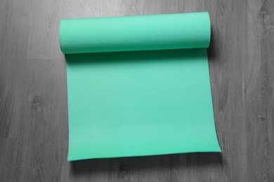 Photo of Bright camping mat on grey wooden background, top view