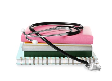 Photo of Stethoscope and notebooks on white background. Medical students stuff