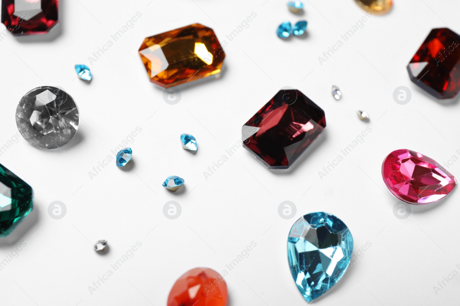 Photo of Different beautiful bright gemstones on white background