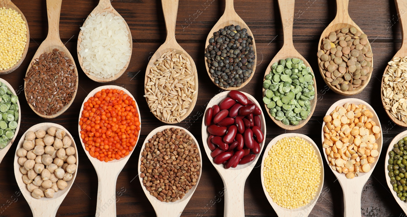 Photo of Flat lay composition with different types of legumes and cereals on wooden table. Organic grains