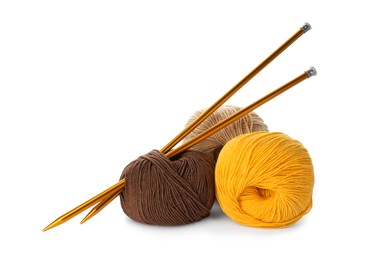 Soft woolen yarns and knitting needles on white background