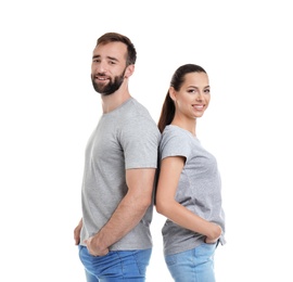 Photo of Young couple in t-shirts on white background. Mockup for design