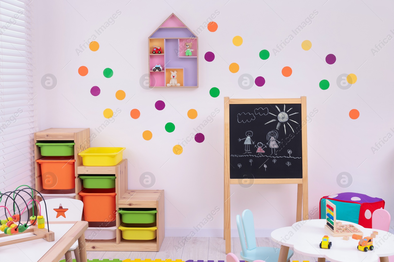 Photo of Stylish kindergarten interior with toys and modern furniture