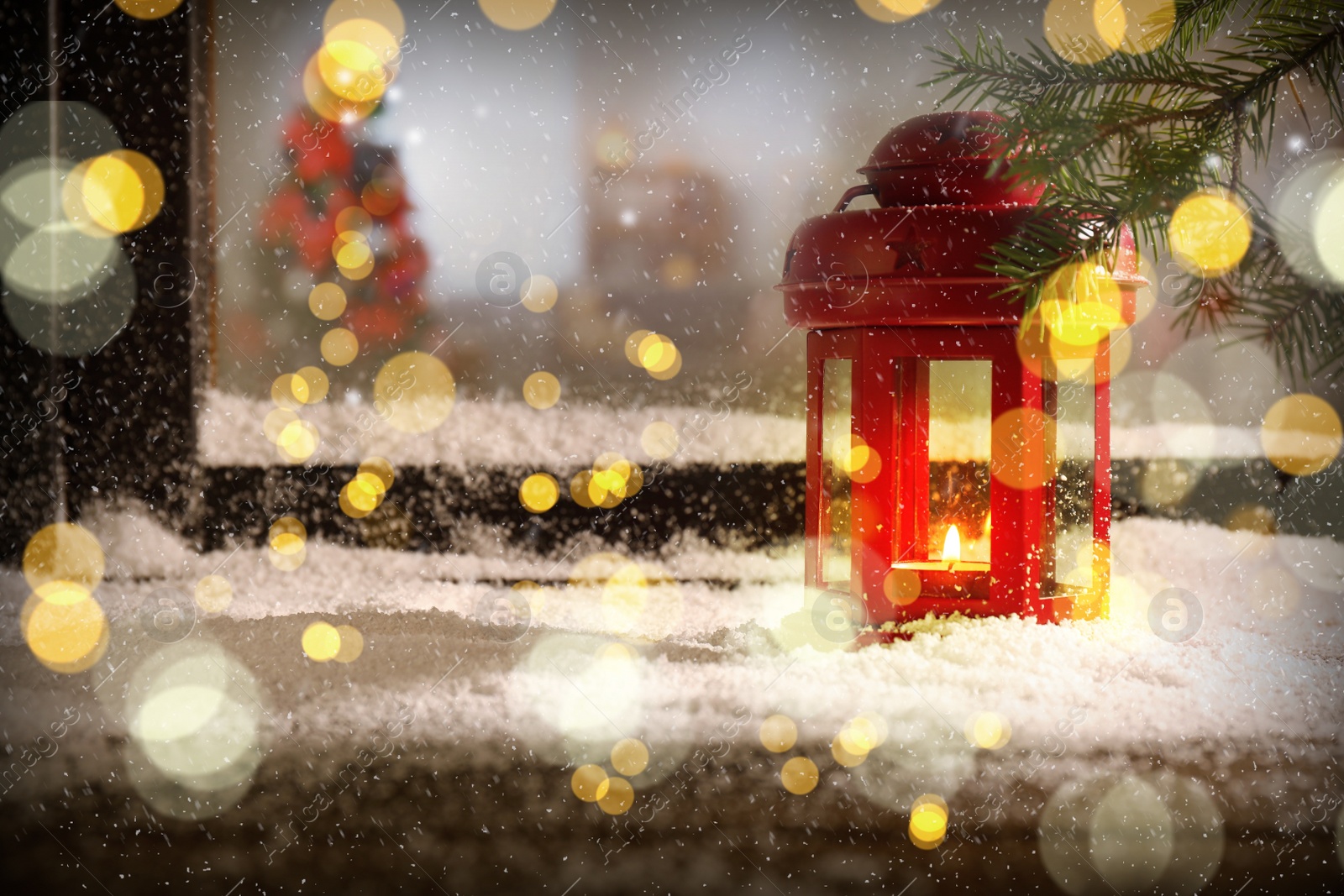 Image of Red lantern with candle near window outdoors. Christmas eve