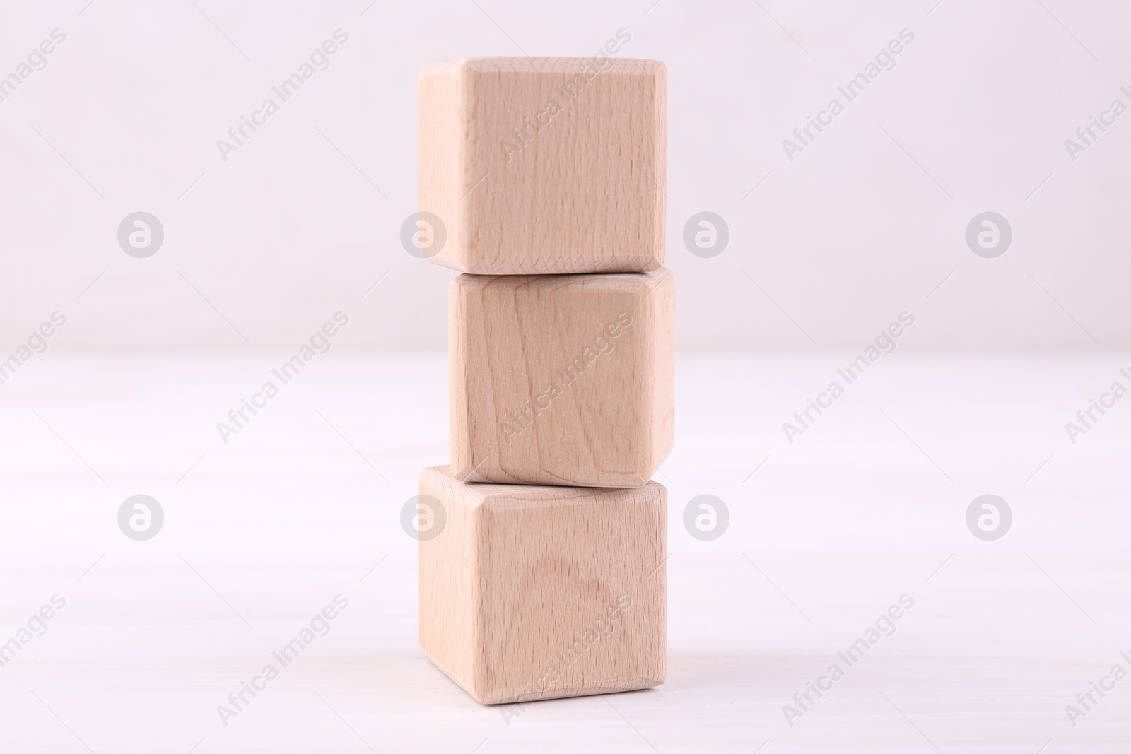 Photo of International Organization for Standardization. Wooden cubes with abbreviation ISO on white table, closeup