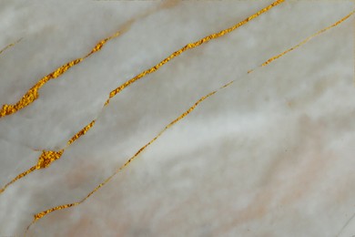 Image of Beautiful gray and gold marble surface as background