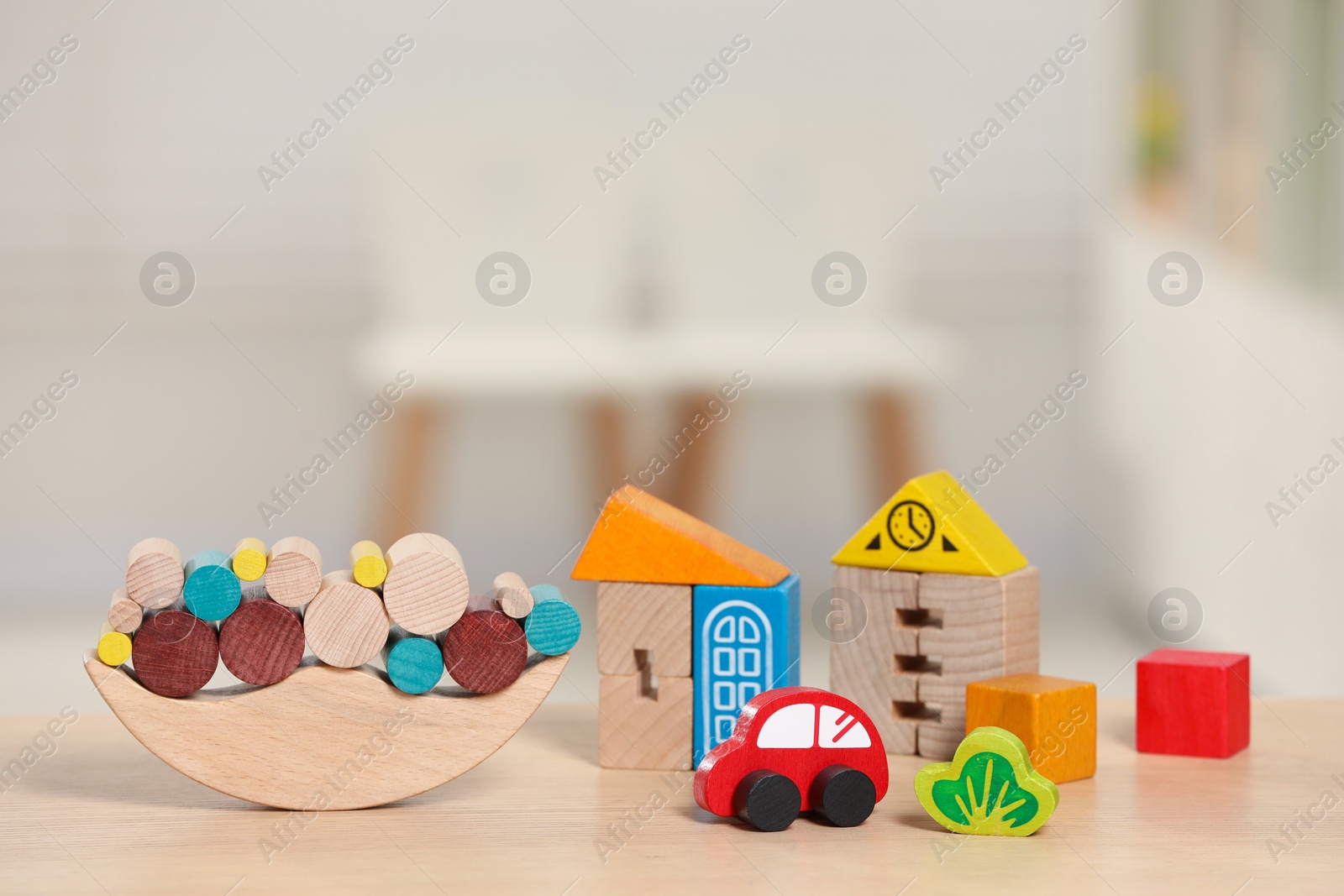 Photo of Set of wooden toys on table indoors, closeup. Space for text. Children's development