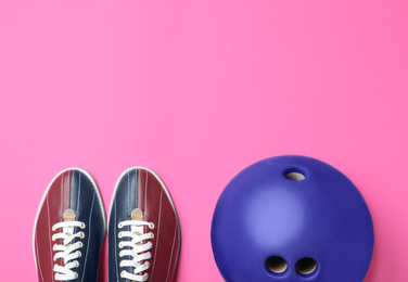 Photo of Bowling ball and shoes on pink background, flat lay. Space for text