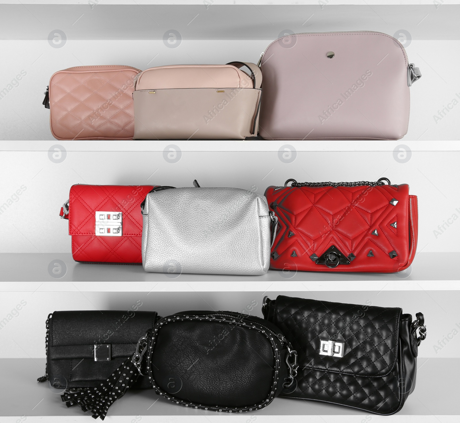 Photo of White shelving unit with stylish purses, closeup. Element of dressing room interior