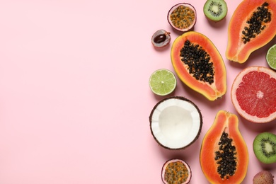 Fresh ripe papaya and other fruits on pink background, flat lay. Space for text