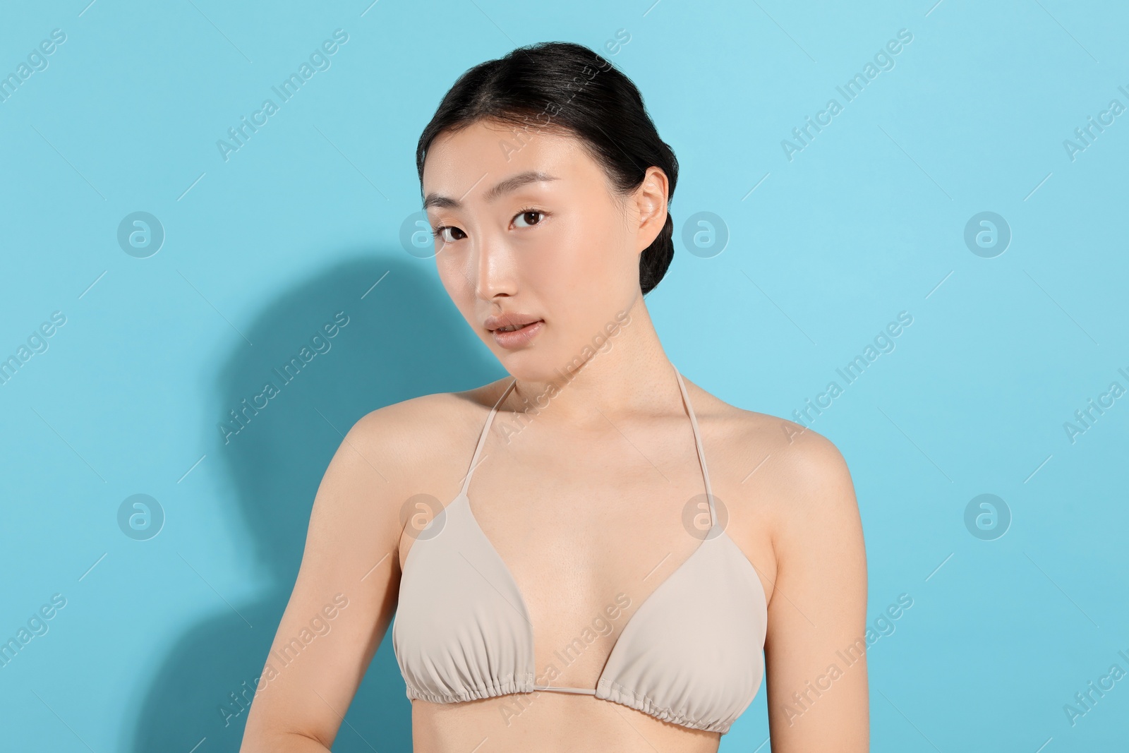 Photo of Beautiful young woman on light blue background