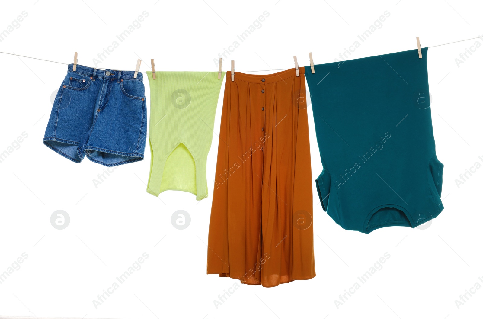 Photo of Different clothes drying on laundry line against white background