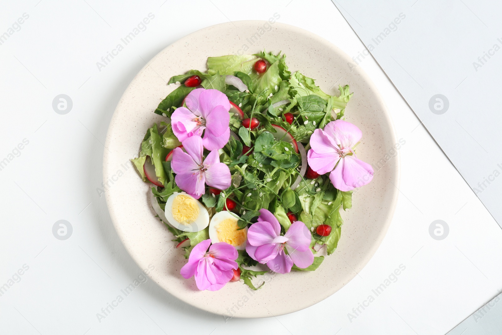 Photo of Fresh spring salad with flowers isolated on white, top view