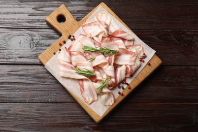 Photo of Slices of raw bacon and spices on wooden table, top view