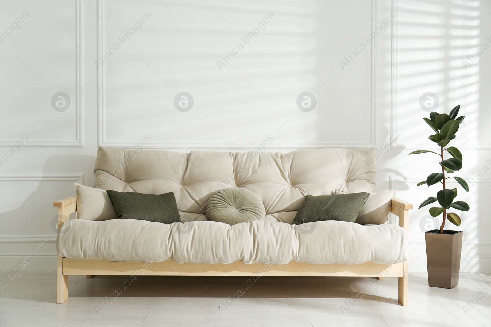 Photo of Stylish beige sofa in living room interior