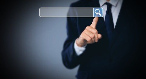 Image of Man pointing at search bar on virtual screen against dark background, closeup. Banner design