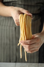 Photo of Woman with homemade pasta at table, closeup