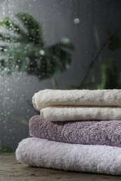 Photo of Stacked terry towels on table in bathroom