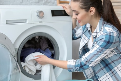 Young woman doing laundry at home