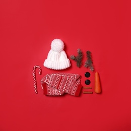 Set of elements for snowman on red background, flat lay