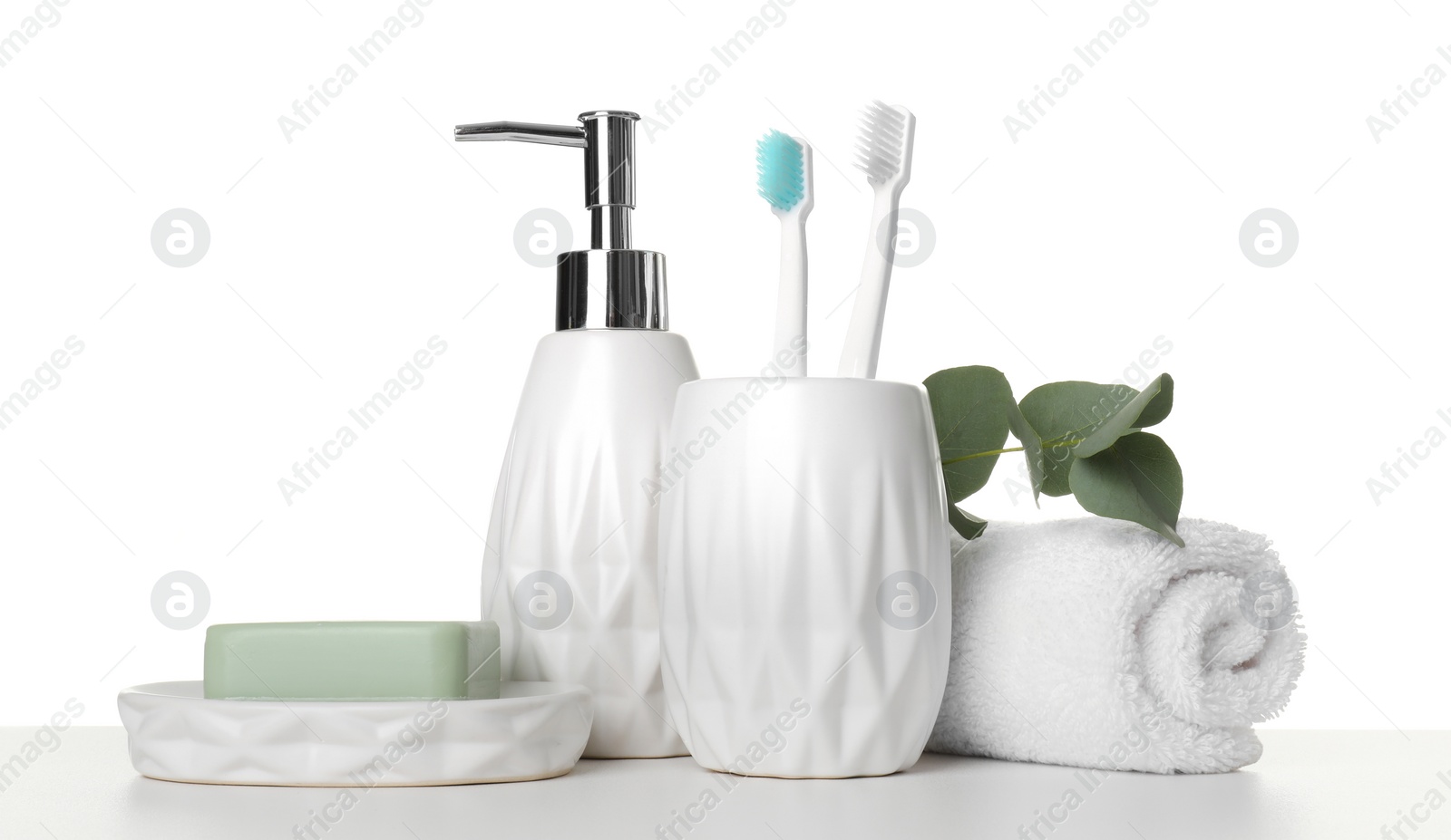 Photo of Bath accessories. Different personal care products and eucalyptus branch on table against white background