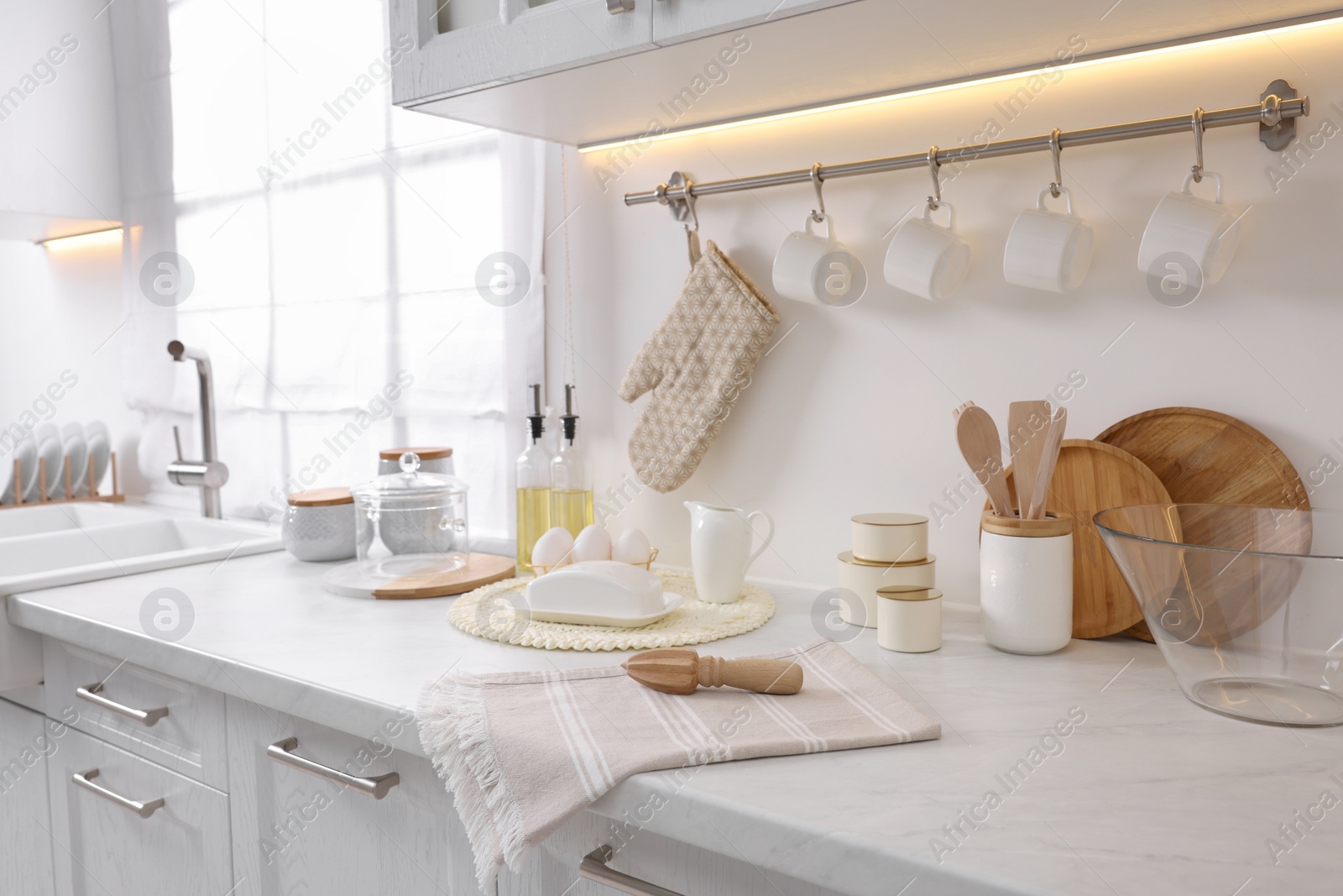 Photo of Set of different utensils and dishes on countertop in kitchen