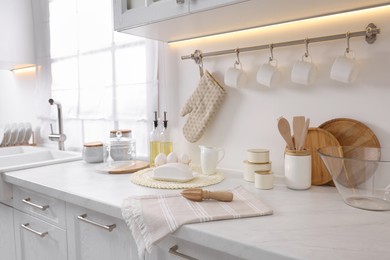 Set of different utensils and dishes on countertop in kitchen