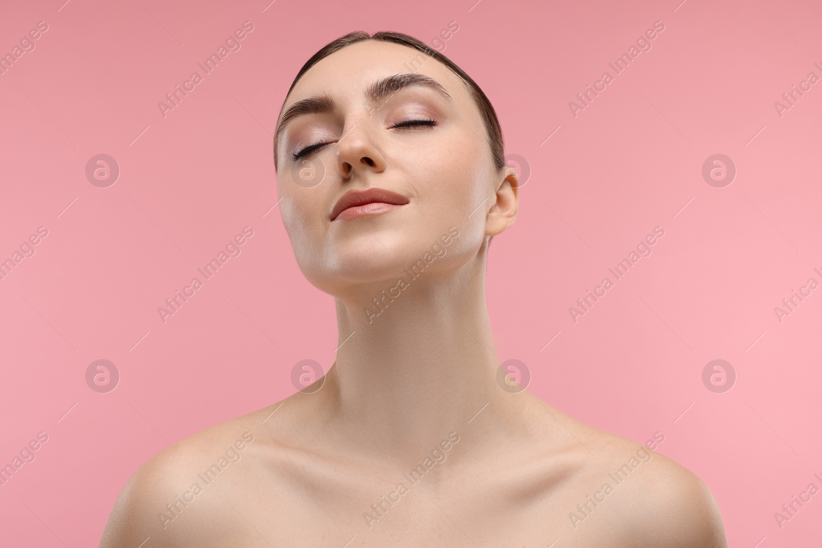 Photo of Portrait of beautiful woman on pink background