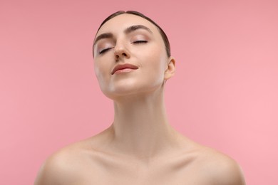 Portrait of beautiful woman on pink background