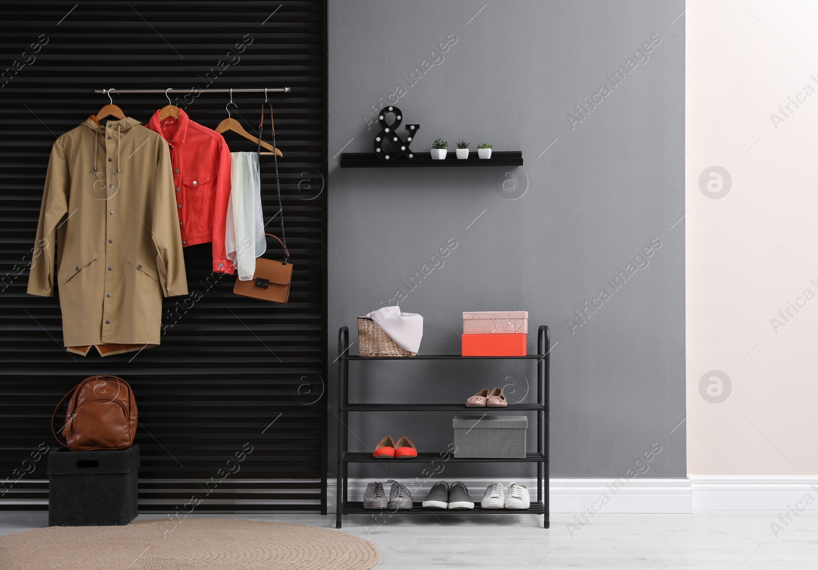 Photo of Hallway interior with stylish furniture, clothes and accessories